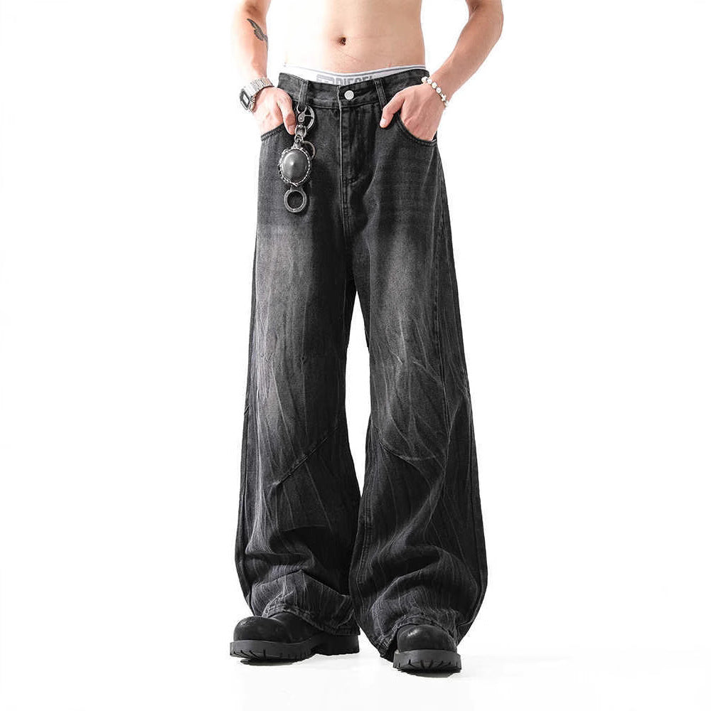 Person wearing loose-fitting black jeans on a white background